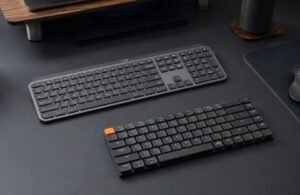 Logitech MX Keys S and Keychron K3 resting on a modern, minimalist designer desk, lifestyle tech photography, cinematic lighting, ultra-detailed, 8k resolution, shot on 35mm lens, photorealistic.
